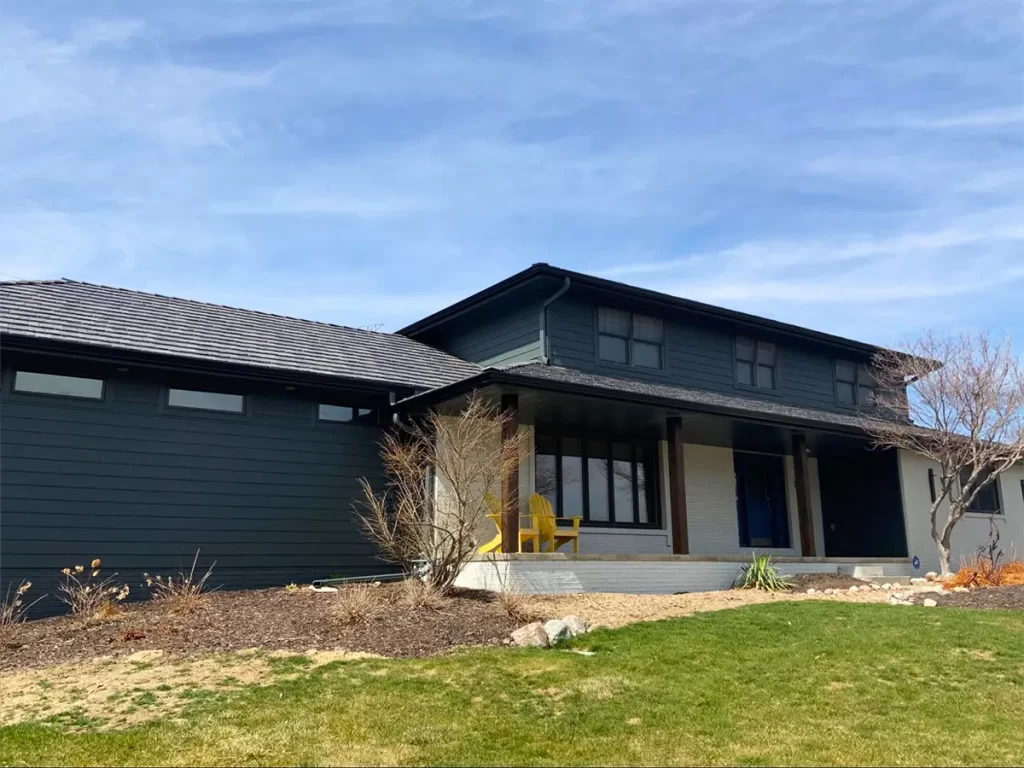 Contemporary dark-toned home with sleek roofing, featuring clean lines and minimalist design.