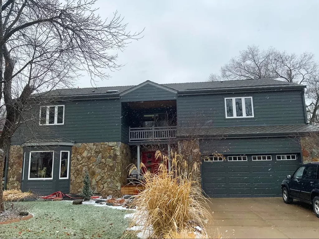 Two-story house with a fresh roof installation, blending modern aesthetics with functionality.
