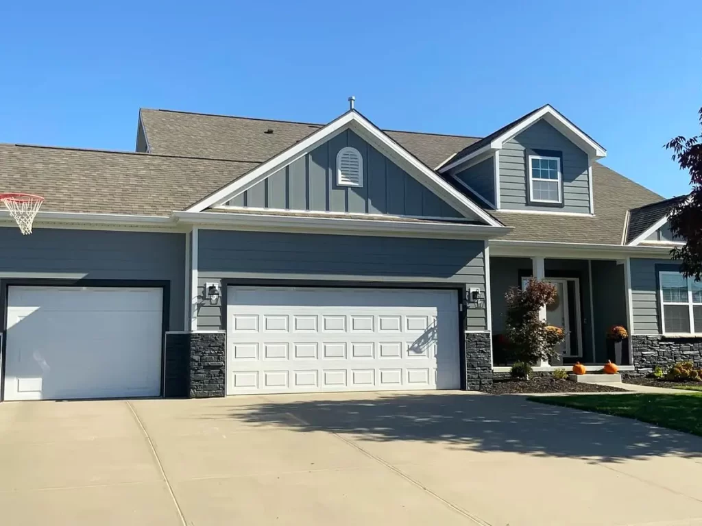 Modern farmhouse with gray siding, clean lines, and a welcoming front porch.
