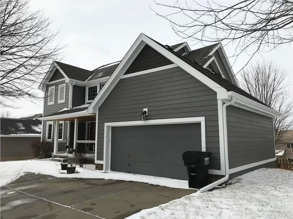 Gray two-story house with HardiePlank® Lap Siding and a clean, minimalist garage facade.