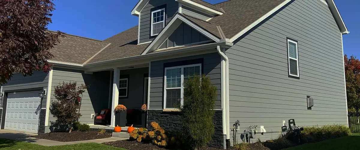 Single-story house with gray Hardie board siding, gable roof, and front yard landscaping
