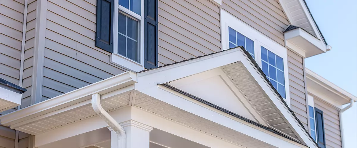 Portico leading to the entrance of vinyl horizontal lap siding covered building
