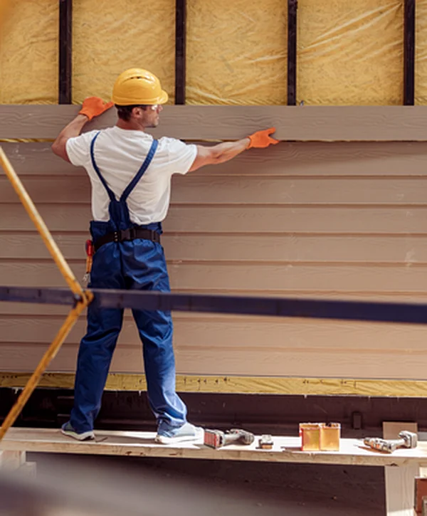 siding installation elkhorn ne siding professional contractor installing beige siding on insulated exterior wall