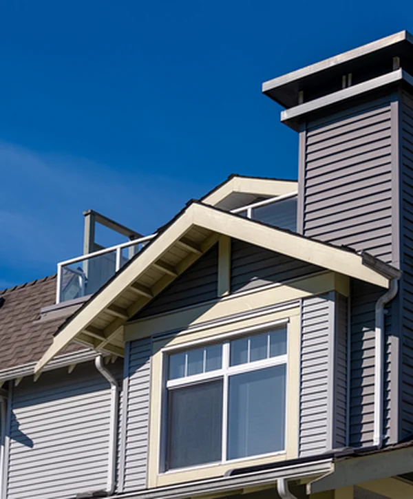 siding repair north omaha ne siding gray vinyl siding and gabled roof on modern residential building under blue sky