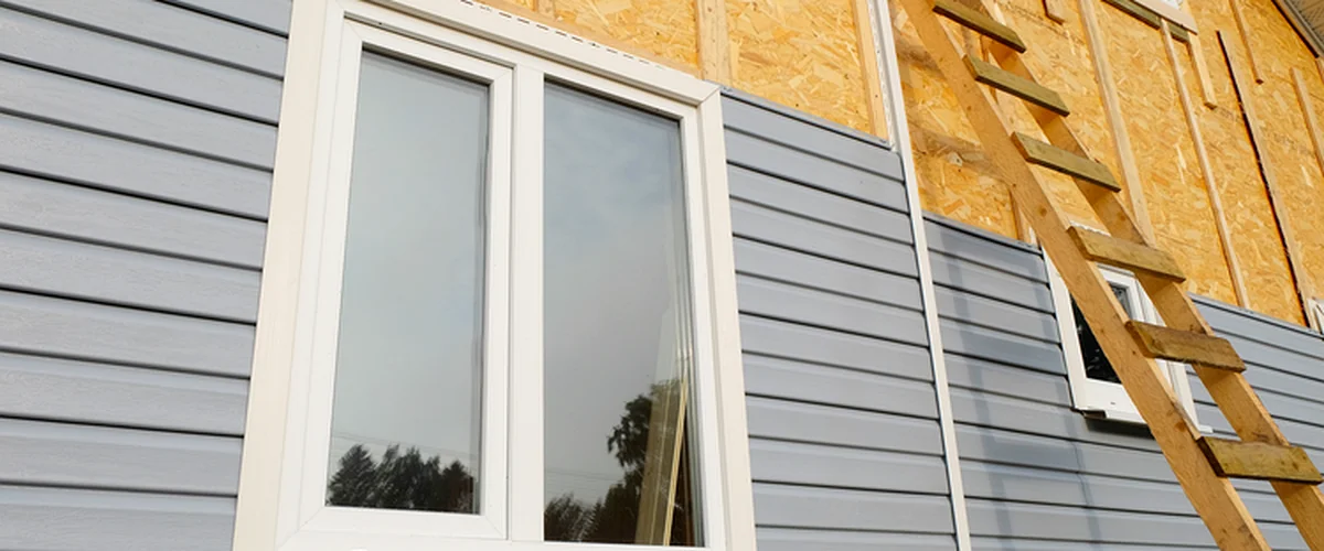 siding replacement bellevue ne siding gray horizontal siding installation with wooden ladder showcasing expert craftsmanship