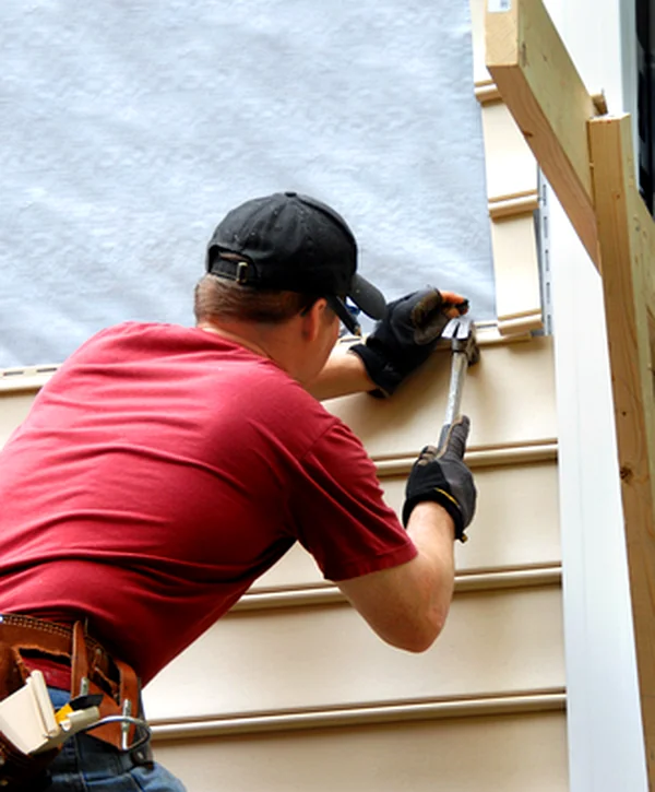 siding replacement bellevue ne siding professional contractor installing beige vinyl siding with expert precision tools