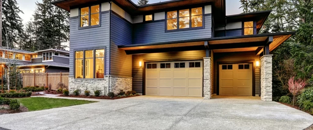 siding modern two story house with blue siding stone accents and spacious driveway