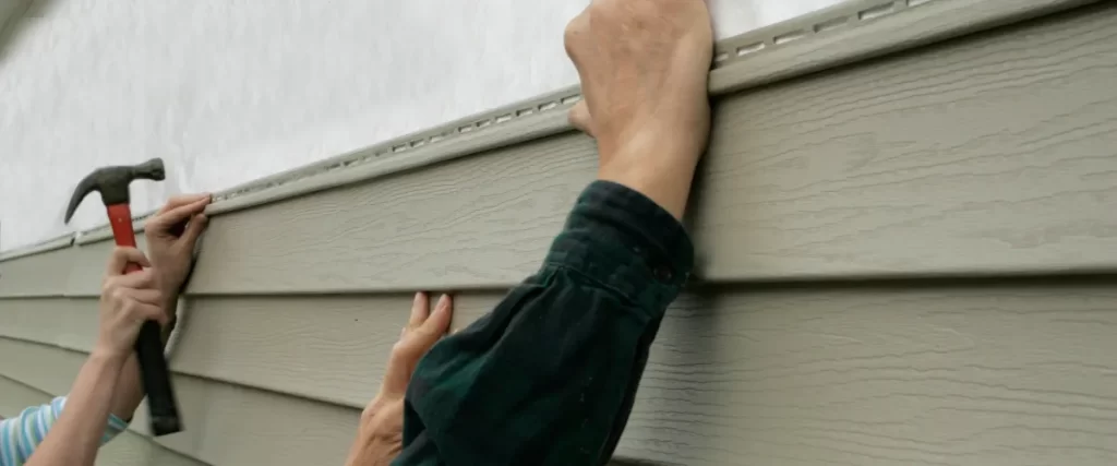 people installing siding on a building