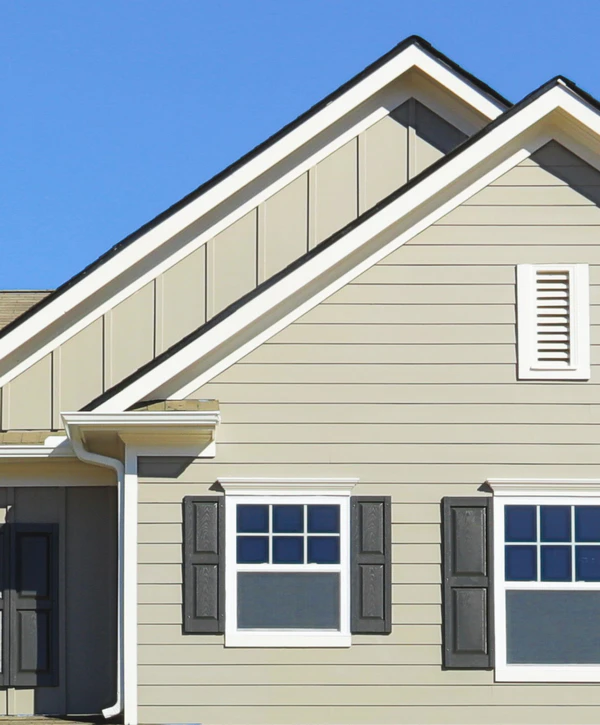 Light beige house exterior featuring horizontal lap siding, white trim, and dark window shutters, highlighting recent siding repair in South Omaha, NE.