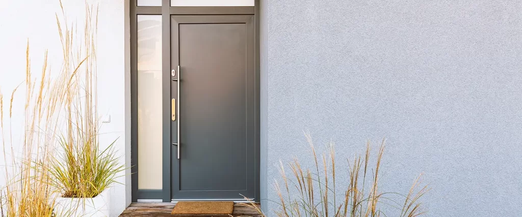 Modern front entry door with sidelights installed for enhanced curb appeal and home security
